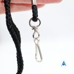 Holding black cord lanyard with swivel clip