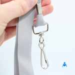 Holding grey flat lanyard with swivel clip