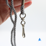 Holding silver grey lanyard with swivel clip